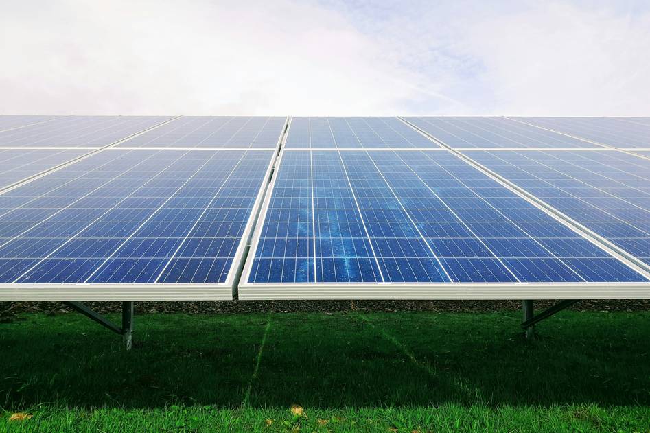 Solar technician inspecting connector junction on residential rooftop array